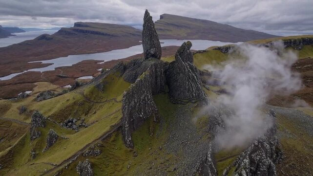 view from above of notable rock formation characterized by rugged topography and low-lying clouds situated on northern island