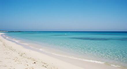 Fototapeta premium A serene view of a beautiful beach with crystal clear water, inviting a sense of tranquility and peace. The scene captures a perfect summer day by the sea.