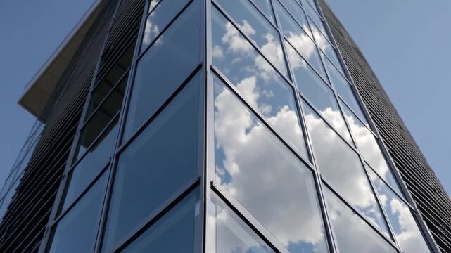 detailed perspective of modern architectural structure highlighting reflective glazed sections mirroring faint cumulus formations and azure firmament, accentuating balanced proportions and metropolit