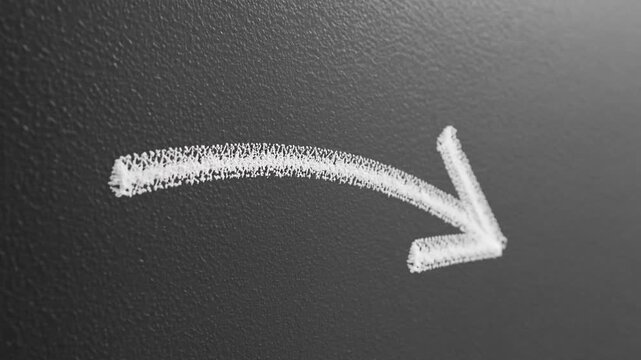chalk drawn arrow moving down on blackboard