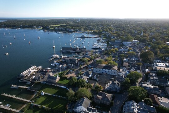 Aerial view of coastal town with marina on a sunny day.