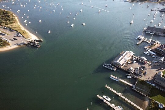 Aerial view of marina with boats and coastline