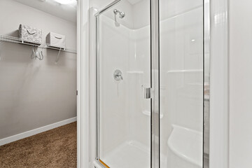 Bathroom with a shower and a white door