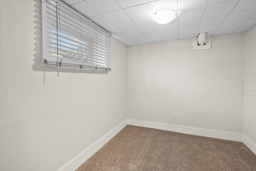 Small room with a window and a white wall