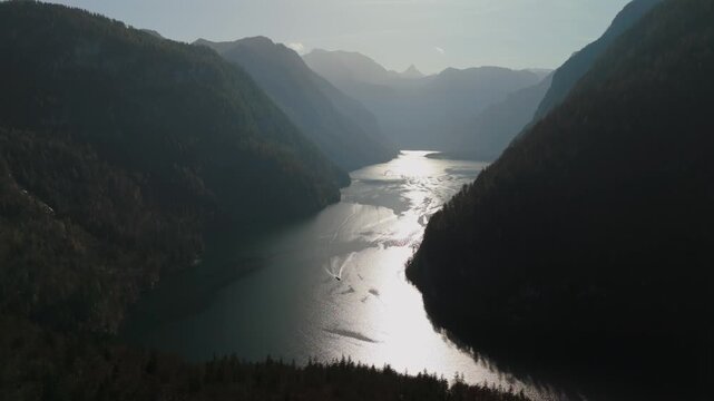 Drone shot over Konigssee in Schonau am Koenigssee, Berchtesgadener Land, Bavaria, Germany. This fjord-like mountain lake lies amidst dramatic peaks and forests in Berchtesgaden National Park. 