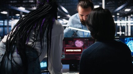 Technicians in AI server hub panicked by hacking attempt stealing sensitive company data. Team of data center IT experts fighting computer virus triggered by security systems, camera A