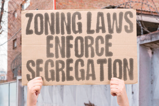 "Zoning laws enforce segregation" highlighting systemic injustice in city design.JUSTICE. EQUALITY. HOUSING. RIGHTS. POWER. CITY. POLICY.