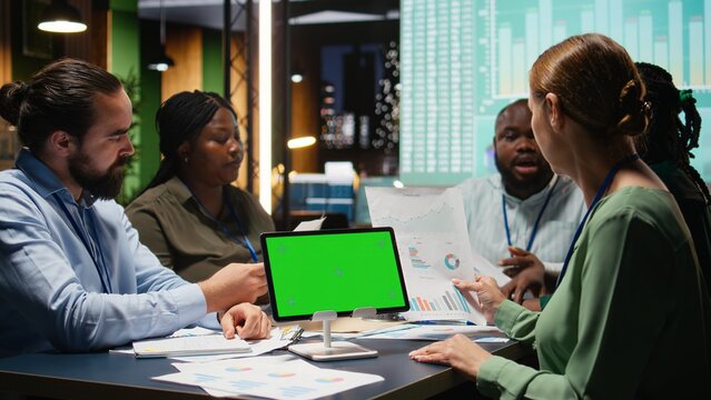 Coworkers team work late at night reviewing reports with copy space, analyzing trends and collaborating on strategy updates supported by visual data. Company projections with analytics. Camera A. - Powered by Adobe