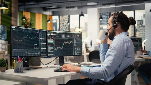 Financial advisor in office offers personalized investment guidance during live calls with clients. Consultant talking in headset mic, helping customers build tailored portfolio