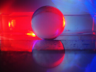 A colorful ball is sitting on a glass pedestal. The colors of the ball and the pedestal are vibrant and eye-catching. Scene is energetic and lively, as if the ball is a symbol of fun and excitement