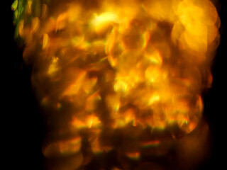 Colorful light leaks on black background for design and special effects. Retro film look. Abstract colorful light beams.