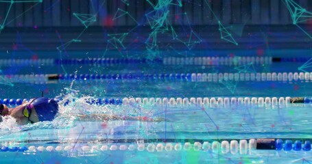 Female swimmer entering pool lane and initiating freestyle strokes under sports tech overlay - Powered by Adobe