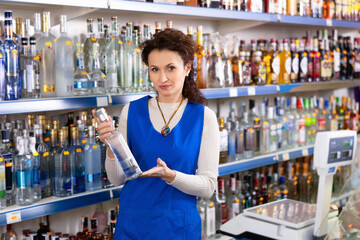 Woman seller offers to buy a bottle of vodka