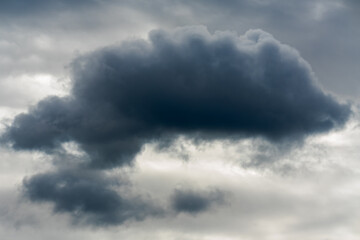Dark Isolated Cloud against Overcast Sky