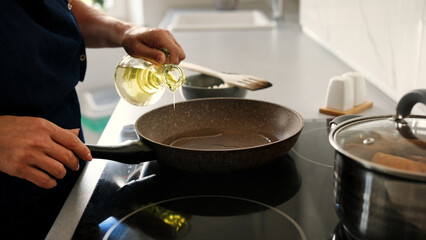 Close-Up Of Woman Pouring Oil Into Pan