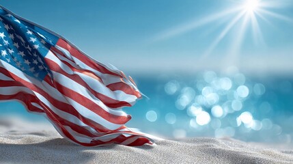American flag fluttering on a sandy beach with bright sunlight and blue ocean in the background during a warm summer day