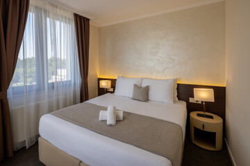 Interior of a hotel room with a large comfortable bed