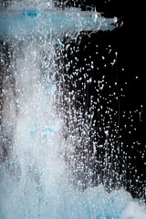 Bubbles rising from a dynamic fountain creating visual splashes in dark surroundings