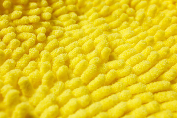 Yellow microfiber cleaning cloth texture closeup background