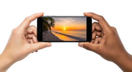 Two hands hold a smartphone displaying a vibrant tropical sunset beach scene.