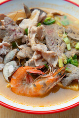 angle view bowl of fresh seafood satay noodles at vertical composition