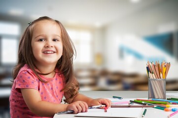 Happy cute children writing for homework at class