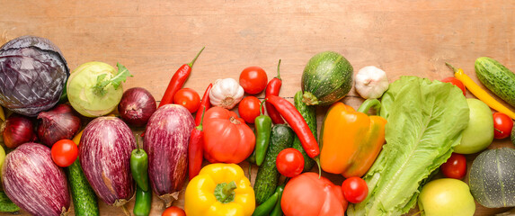 Assortment of fresh vegetables on wooden background