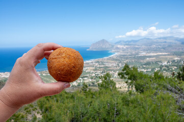Arancini Sicilian, deep-fried rice balls made with risotto, filled with ingredients mozzarella,...