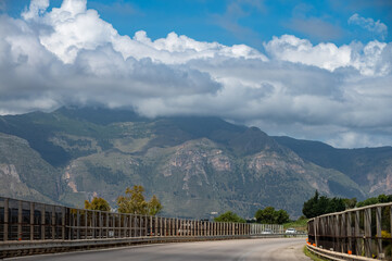 Fototapeta premium Road transportation on Sicily, Italy, green signs guide to cities by highways, blue signs by city roads. Arrows, distances, and exits help travelers navigate Sicily