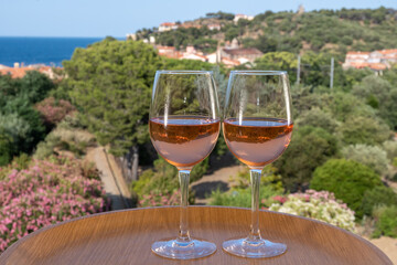 Summer vacation on Mediterranean sea, drinking cold rose wine in glass in sunlights, Collioure, Occitanie, South of France, tourists destination