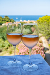 Summer vacation on Mediterranean sea, drinking cold rose wine in glass in sunlights, Collioure, Occitanie, South of France, tourists destination