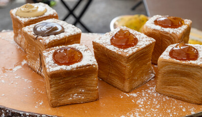 Sicilian desserts, sweets, cakes with ricotta cream, fruits, pistachio, on display in confectionery artisan shop