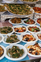 Delicious fresh cooked street food on daily food market in Palermo, Sicily, travel destination, food tourism Italy, variety of raw, roasted, grilled fish, seafood, calamari, sea urchins