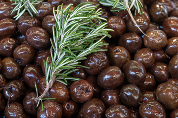Homemade italian pickled black olives with garlic and spices on food market in Palermo, Sicily, italy