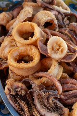 Delicious fresh cooked street food on daily food market in Palermo, Sicily, travel destination, food tourism Italy, variety of raw, roasted, grilled fish, seafood, calamari, sea urchins