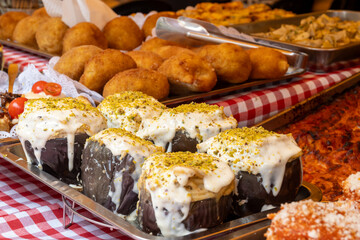 Delicious fresh cooked street food on daily food market in Palermo, Sicily, travel destination, food tourism Italy, variety of roasted, grilled fish, seafood, meat, vegetables served snacks, dish