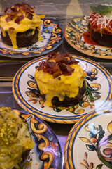 Delicious fresh cooked street food on daily food market in Palermo, Sicily, travel destination, food tourism Italy, variety of roasted, grilled fish, seafood, meat, vegetables served snacks, dish