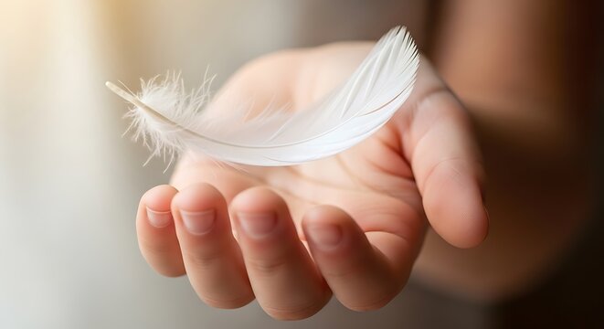 Delicate white feather rests gently on a person s open palm