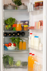 Open fridge full of fresh food. Closeup