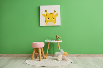 Interior of children's room with table, stool and picture