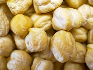 A macro shot of roasted chickpeas or leblebi filling the frame the detailed texture of the crunchy and nutritious snack creates a compelling food-themed background