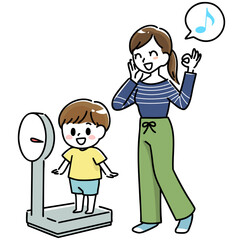 笑顔で体重を測る男の子と母親