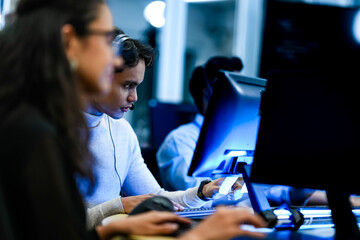 A focused IT specialist uses a security card for system authentication. A concept for...