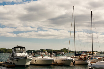 nice view of docked yachts floating on water at sunset time, summer gorgeous day, sailing travel background