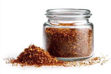 Dried rooibos tea in a glass container set against white background