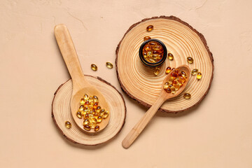 Composition with wooden boards, spoons and jar of fish oil capsules on color background