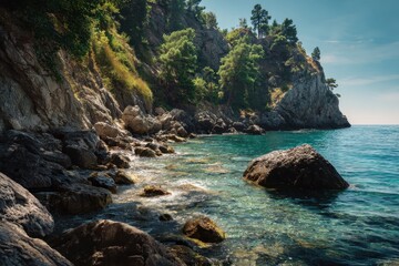 Fototapeta premium Scenic view of a rugged coastline with lush forests by a calm sea in sunlight