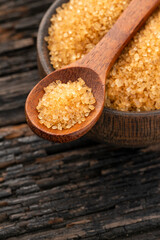 Organic brown sugar in a spoon and bowl - Saccharum officinarum