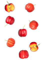 fresh sliced and whole acerola cherries on dark backdrop