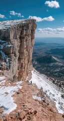 Majestic cliff overlooking a snowy landscape